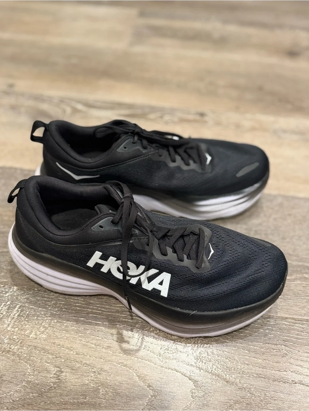 Hoka One One Bondi 8 running shoes feature a black upper and a white midsole